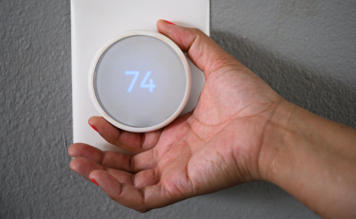 hand adjusting thermostat knob